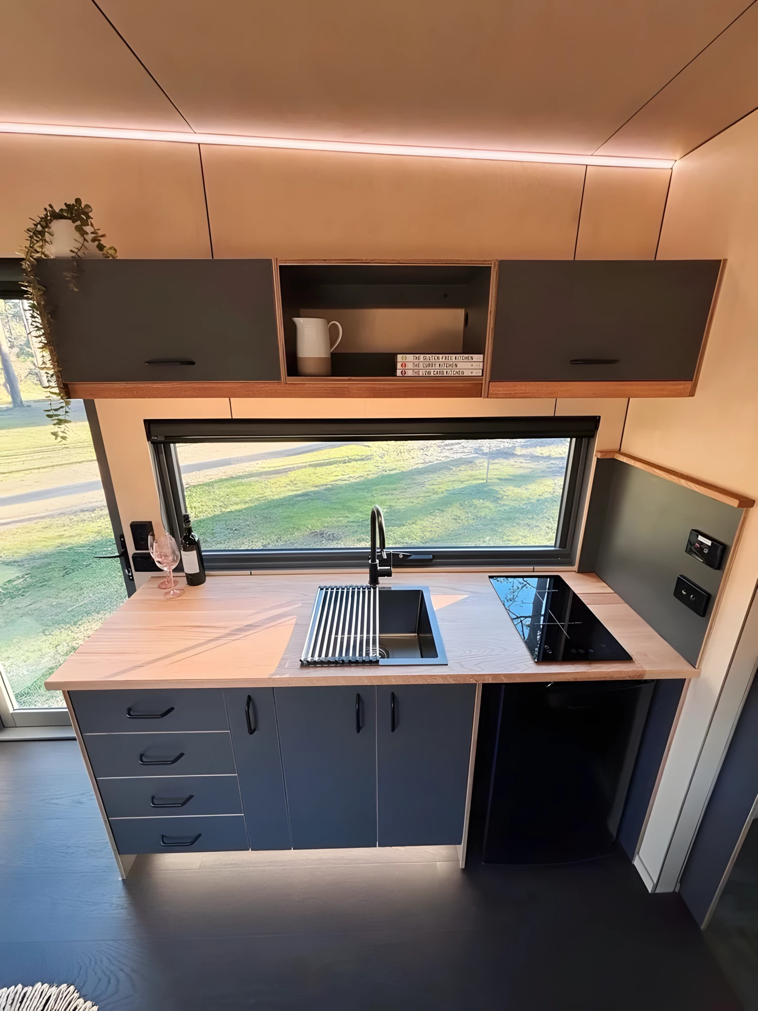 The Chipper BNB's kitchen includes an induction cooktop, sink, and a fridge