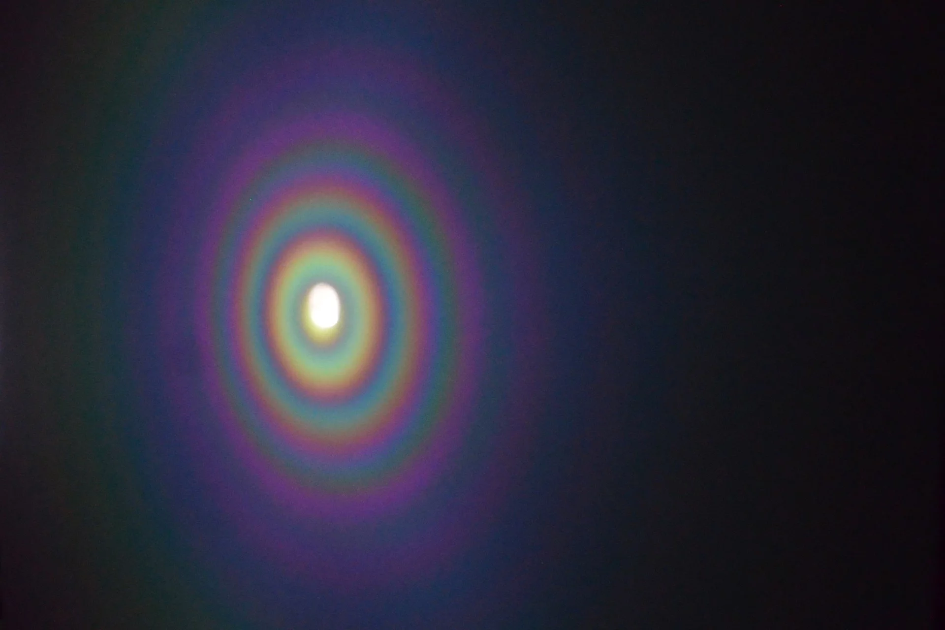 When white light hits the microscale concave interface (MCI), it produces concentric rainbow rings