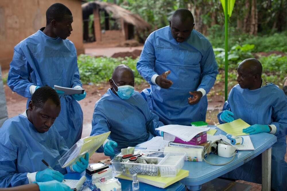 Workers carrying out the WHO Ebola vaccine trial in Katongourou, Guinea
