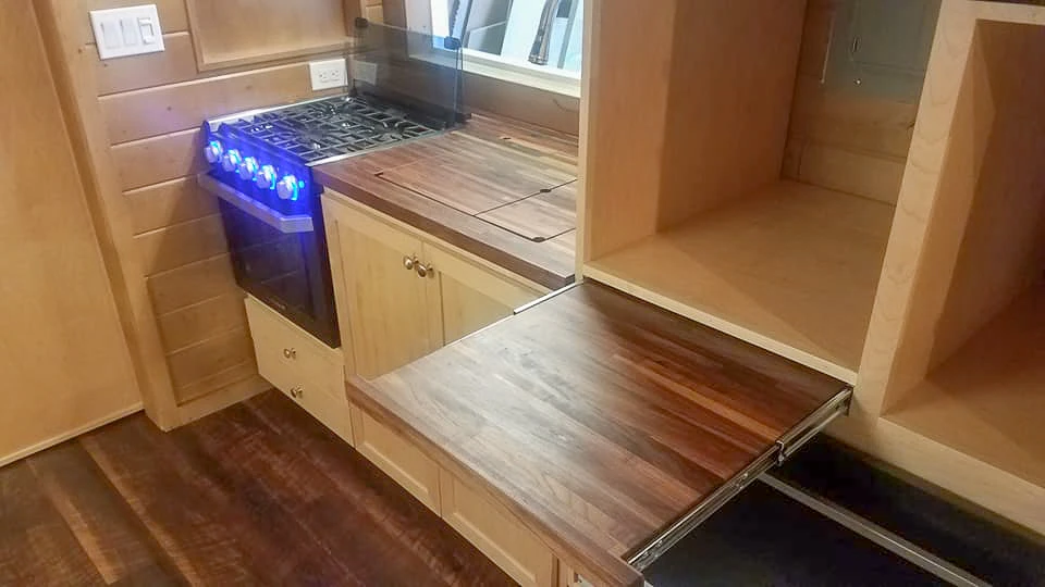 The Ibiza's kitchen includes a breakfast bar, pull-out cutting board, sink, and cooker (the fridge is stowed away nearby under the stairs)