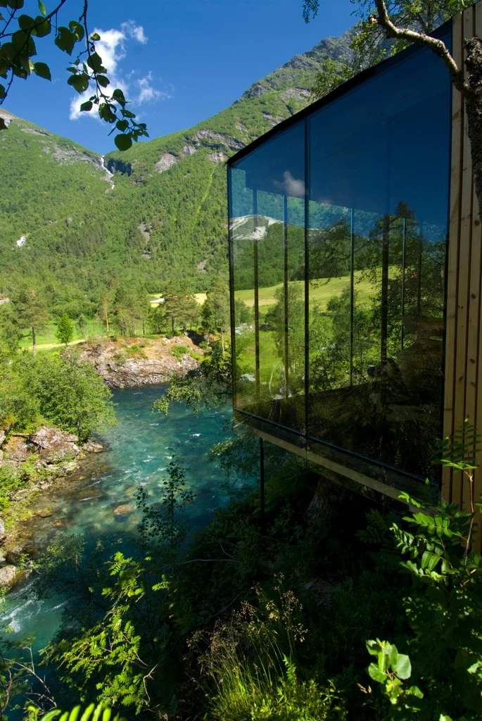Featuring seven small wood cabins perched on a river bank, Juvet is a striking landscape hotel