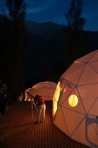 The hotel hosts a series of geodesic domes with elevated loft beds and open rooftops