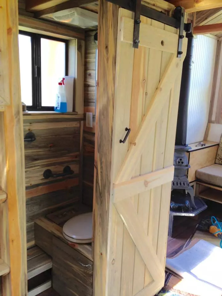 A sliding barn door offers access to the bathroom