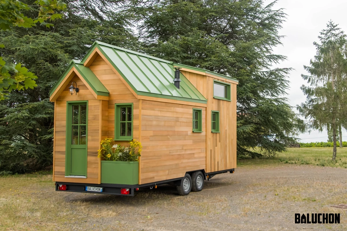 La Mésange Verte features a traditional tiny house exterior and includes a small planter