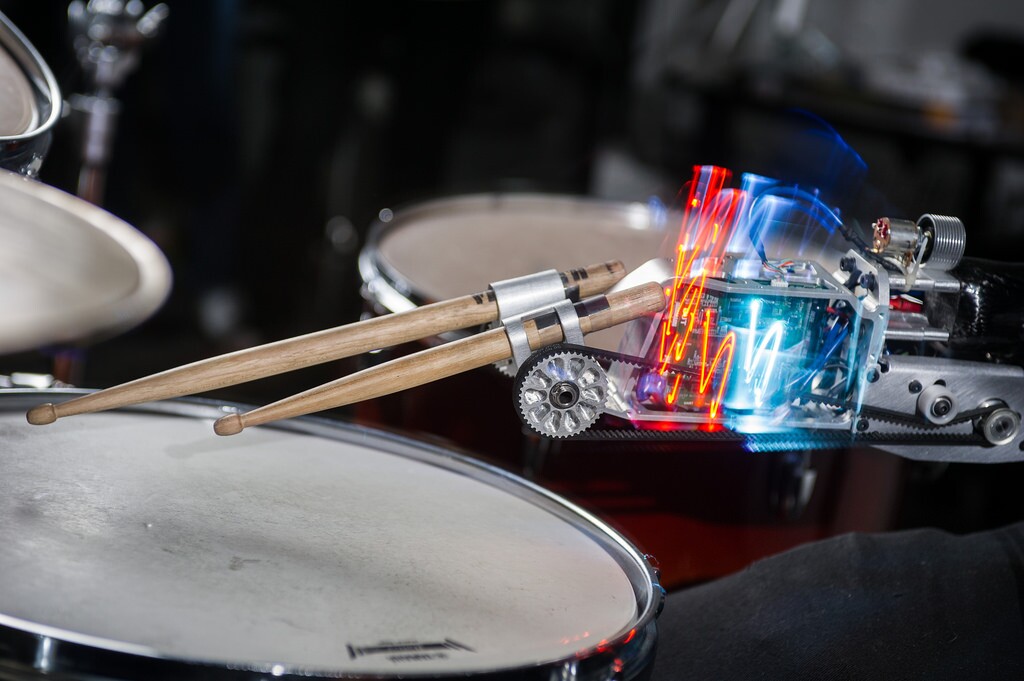 The prosthetic device is home to two drum sticks, one plays in response to sensor readings from the player's biceps, and the other "has a mind of its own"