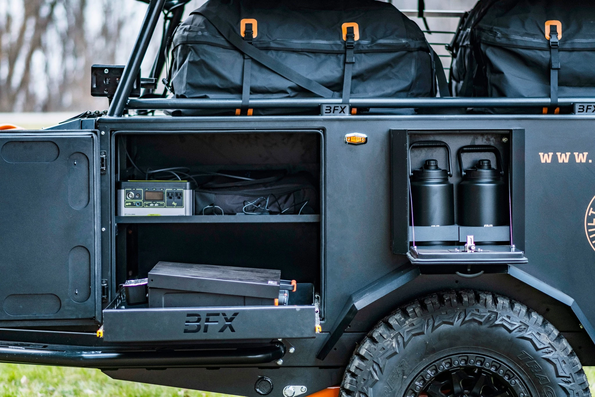 The "Mudbucket" dual-growler holder to the right and the slide-out with Blackstone griddle to the left