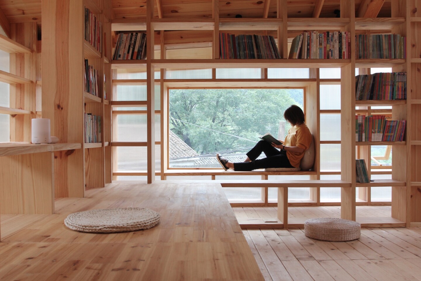 The raised building is located near to a children's playground and parents can sit, book in hand, while keeping an eye on their kids through the windows