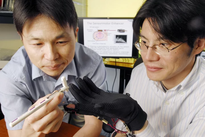 Georgia Tech applied physiology associate professor Minoru Shinohara conducts a single-point touch test on mechanical engineering assistant professor Jun Ueda