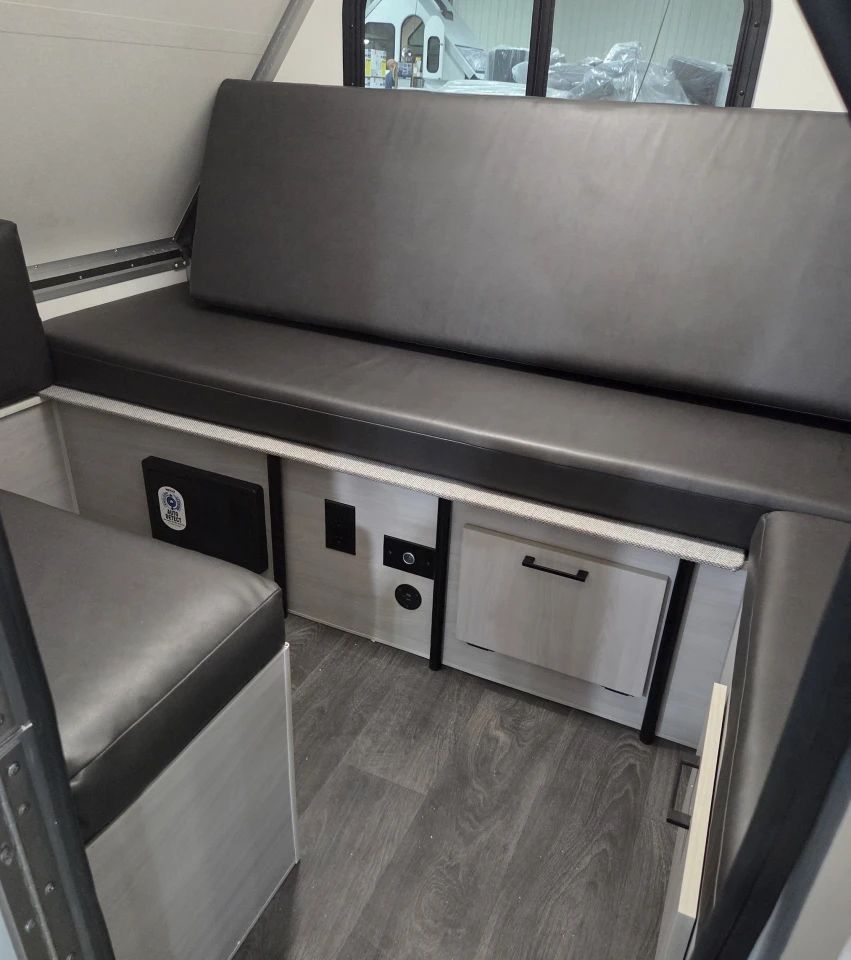 Remove a couple bed cushions, and the Alite interior becomes a cushioned seating group with L-shaped sofa and small bench. The aisle in between can be used to store luggage and other road trip essentials