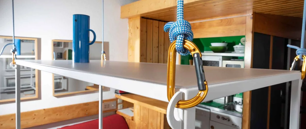 The pulley system allows the table to be lifted up towards the ceiling when not in use
