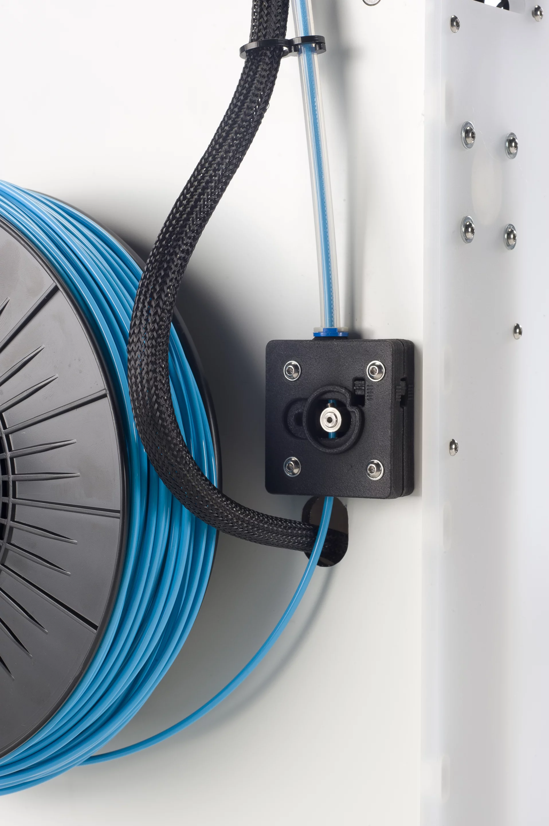 A close up of the feeder through which material enters the printer