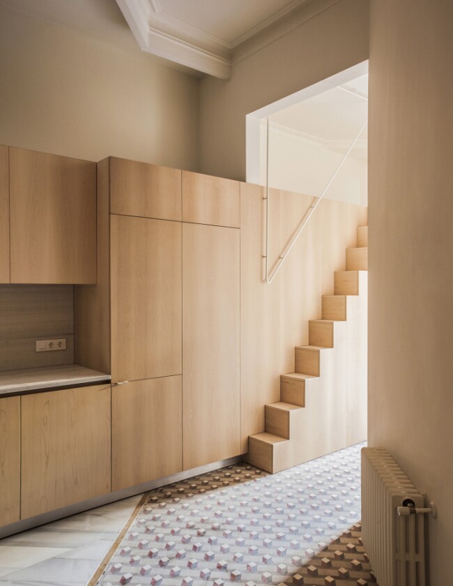 Anna and Eugeni Bach Architects built the central wooden functional wall to provide the home with all the services it needs without stealing space from the home's principal rooms