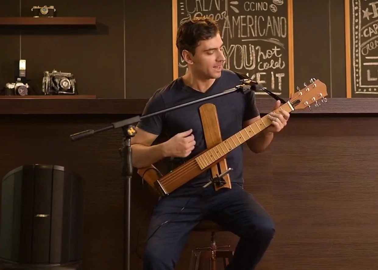 The folding Cross Guitar 2.0 has a built-in headphone amp that can be output to powered speakers