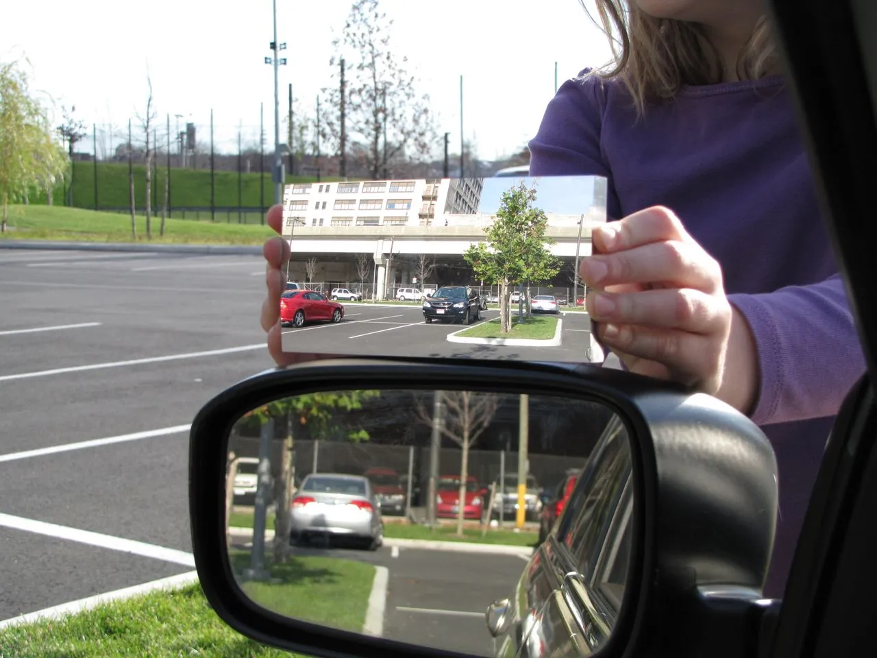 Dr. Hicks' mirror (top) as compared to a regular flat driver's side mirror