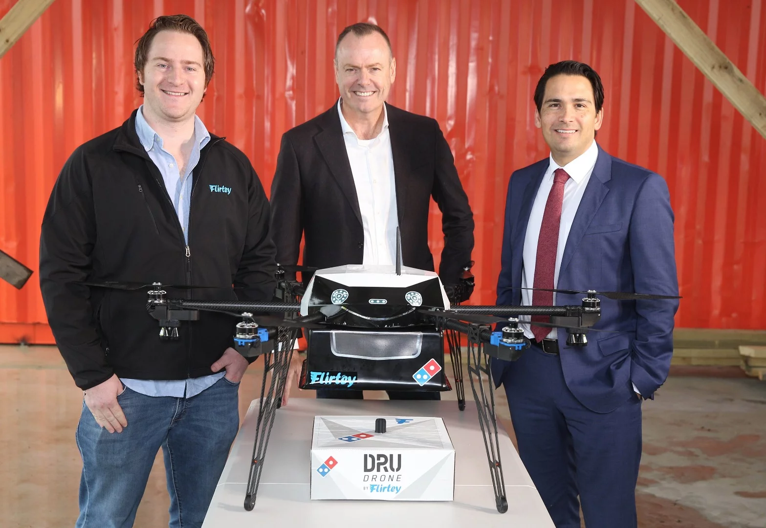Domino's CEO Don Meij (center), with Flirtey CEO Matt Sweeny and New Zealand Minister of Transport Simon Bridges