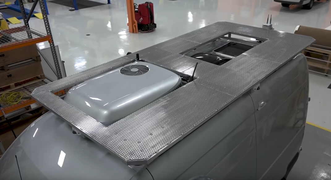 The custom roof rack doubles as a deck for relaxing at camp