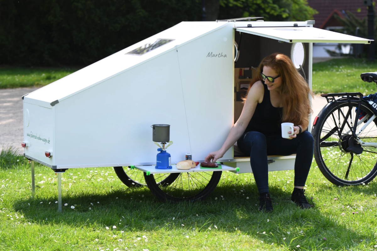 The Maxmess Martha trailer comes with an indoor/outdoor table and a door that doubles as an awning