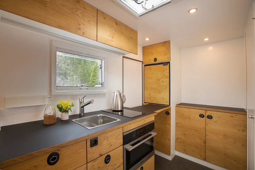 The well-equipped kitchen comes standard with a dual induction cooktop, microwave/oven combo and 130-L refrigerator