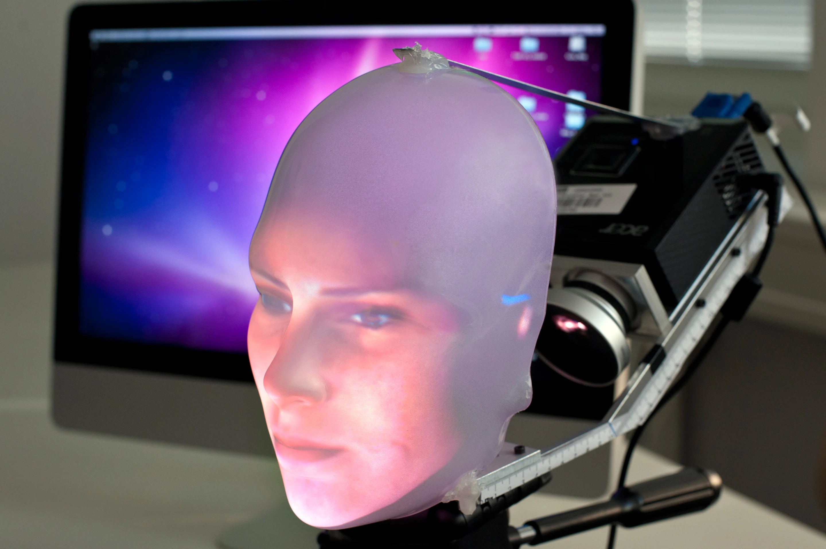 Mask-bot uses a small projector to beam the image of a face onto a transparent plastic mask