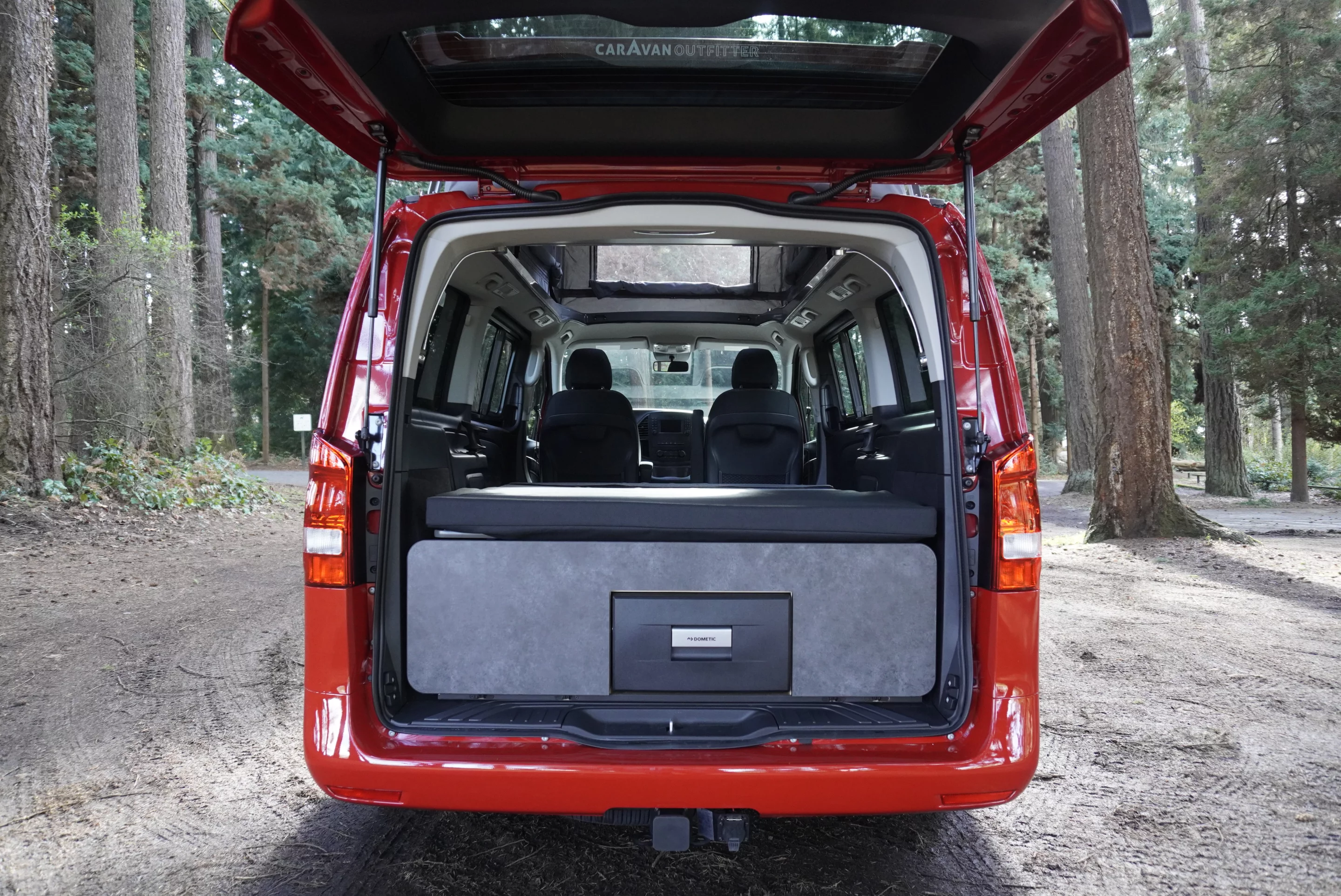 The available kitchen stores neatly below the bed