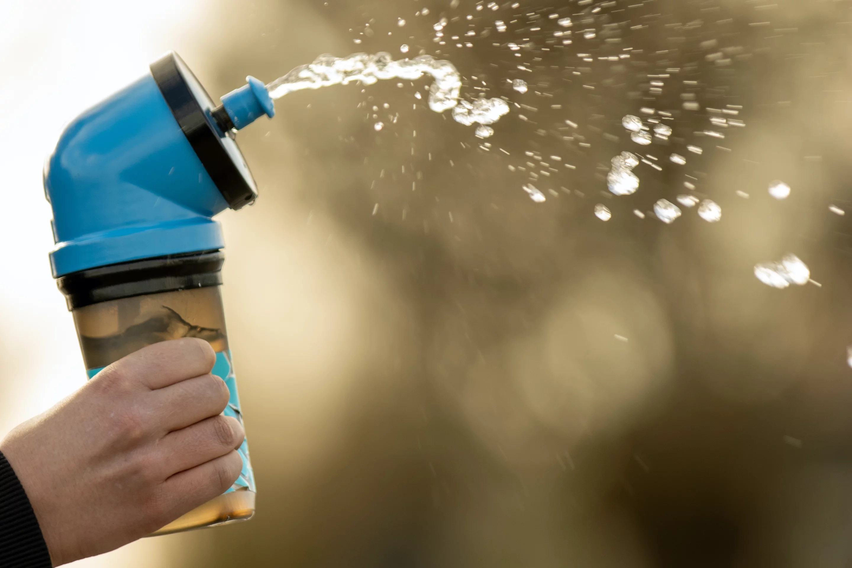 Squeezing the Upright bottle's main body sends water out of the mouth valve