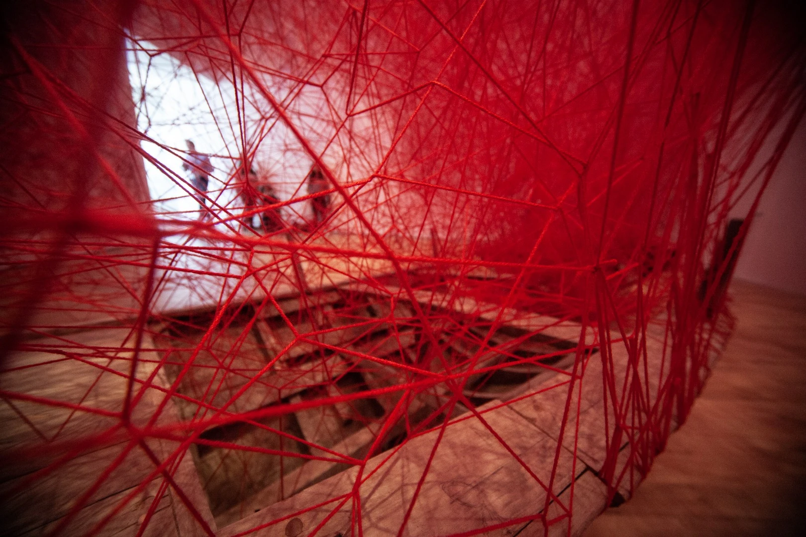A sprawling web of yarns hangs over a traditional Emirati "abra" boat in this installation from Japanese artist Chiahru Shiota