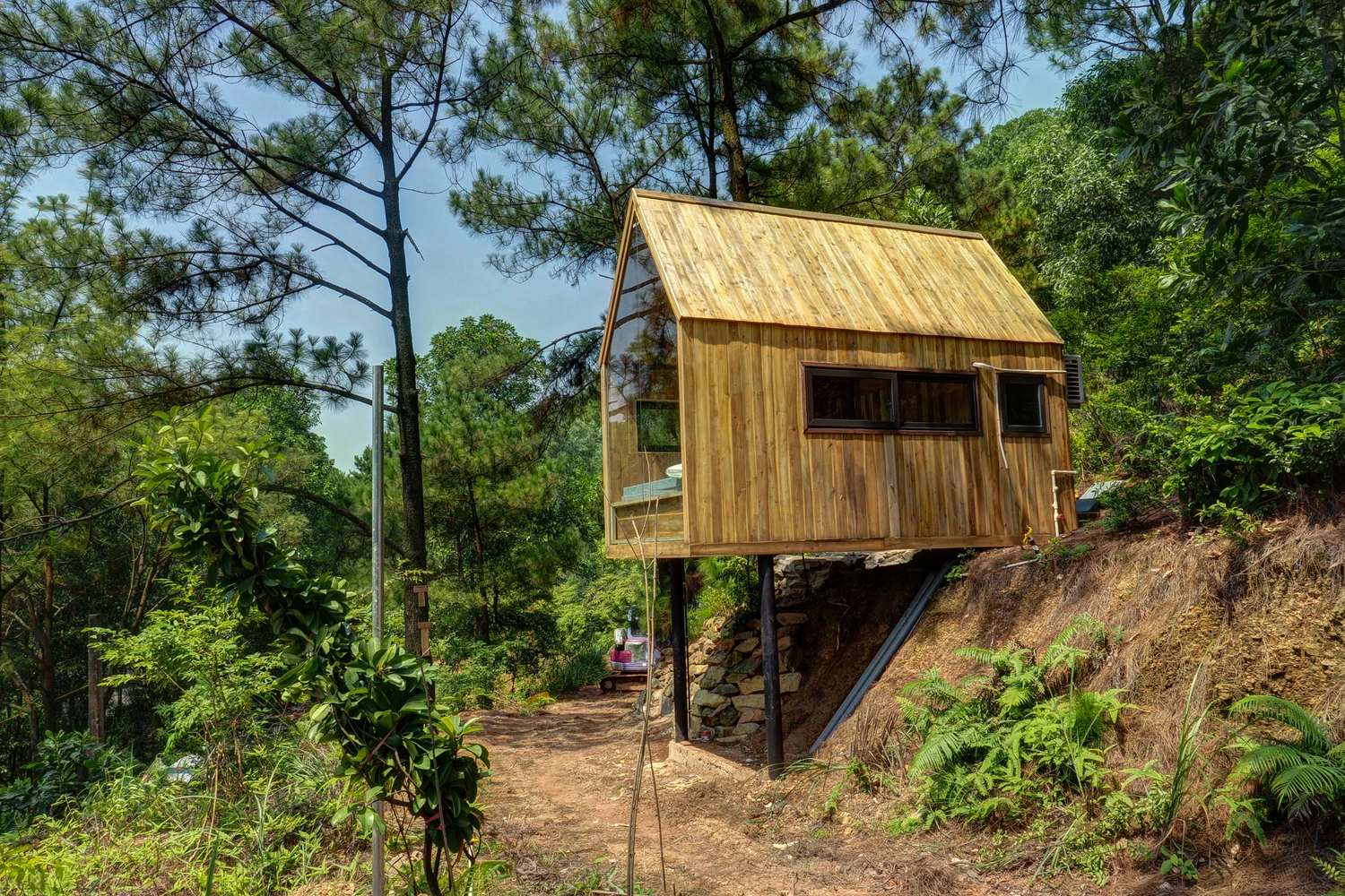 Forest House is one of three projected wooden cabins located amid a vast forest landscape in the Sóc Sơn District, Vietnam