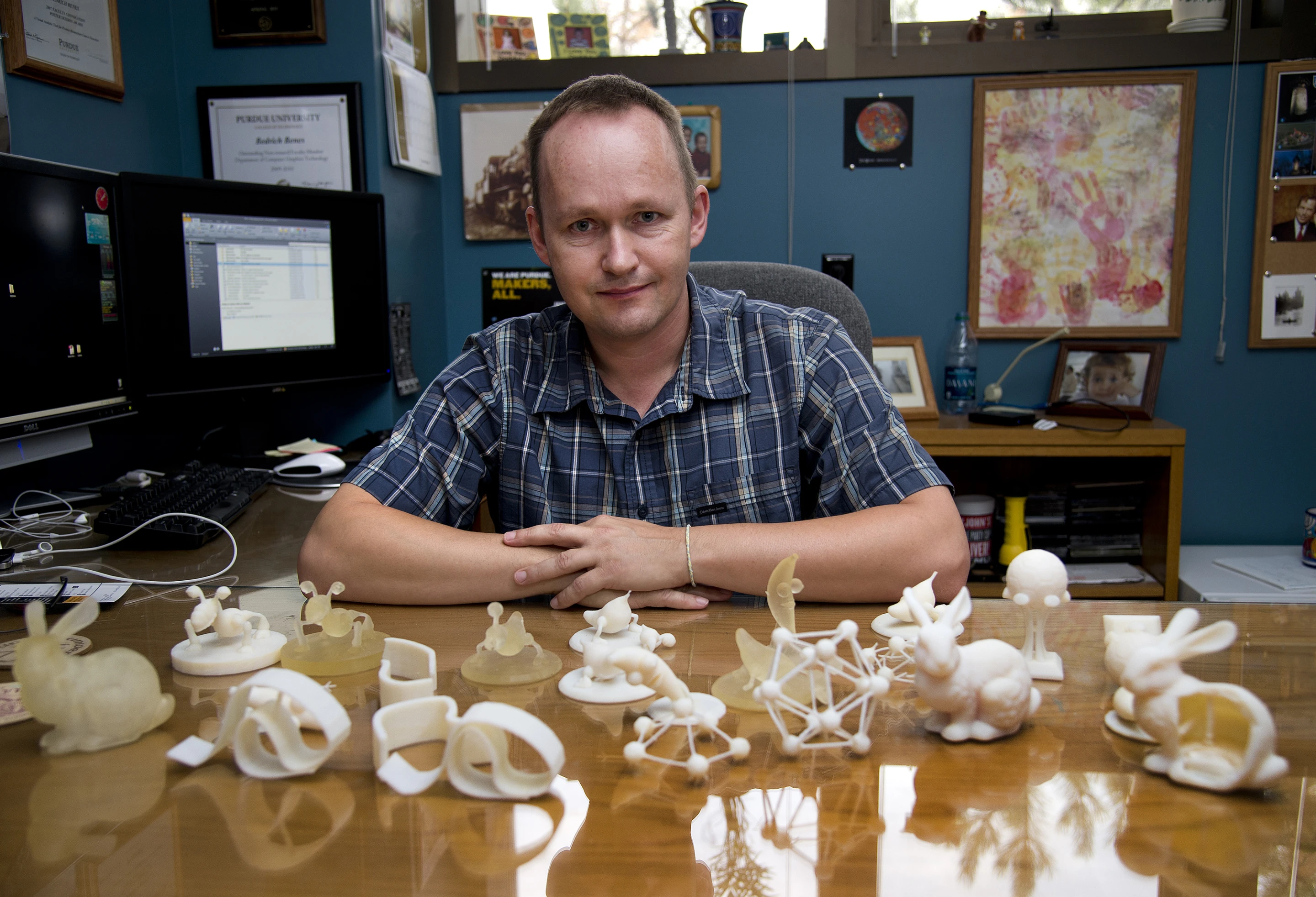 Purdue associate professor of computer graphics Bedrich Benes, with an assortment of objects made with and without the software