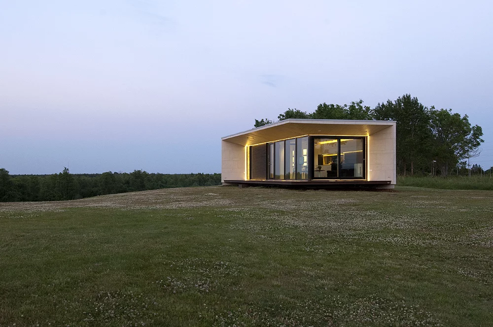 Architect 11 prefers to liken Passion House M1 to a stone house more than a typical prefab build – thanks to its stone-clad facade (Photo: Architect 11)