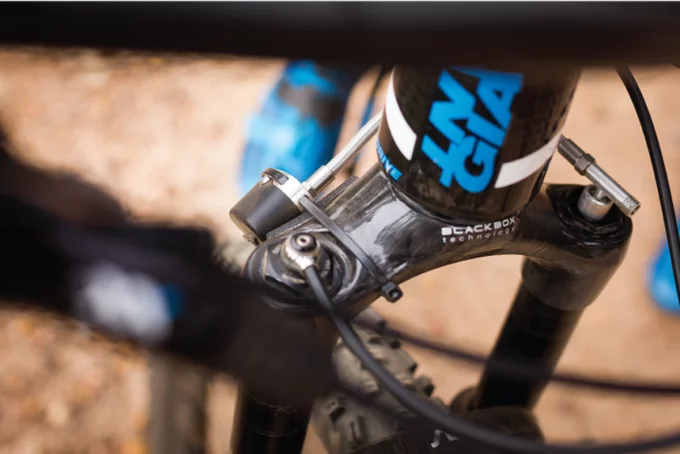 To use ShockWiz, you attach its braided air hose to the Shrader valve on your fork or shock, then zip-tie the main device to the frame or fork crown
