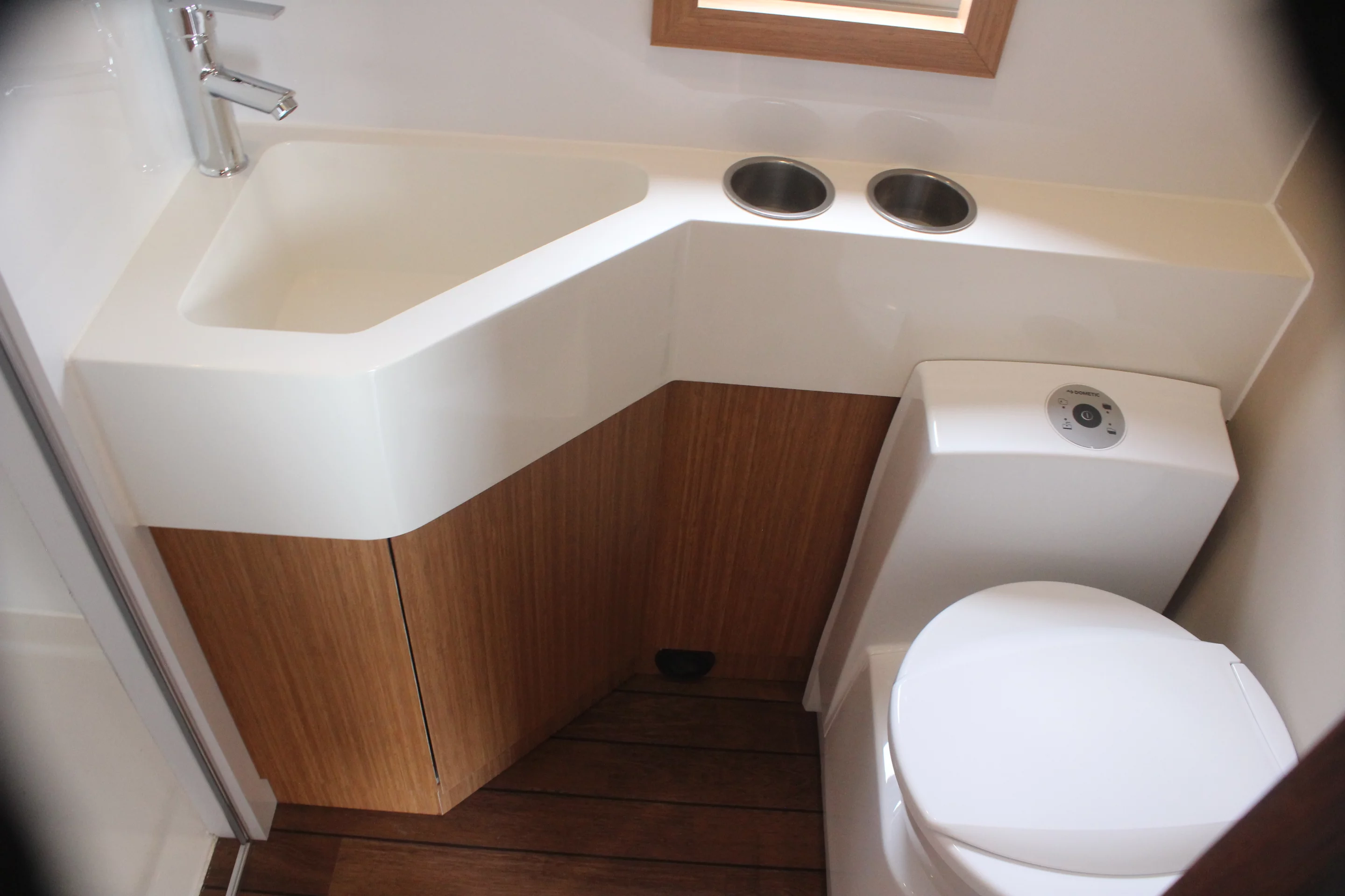 The bathroom has a shower, toilet and sink