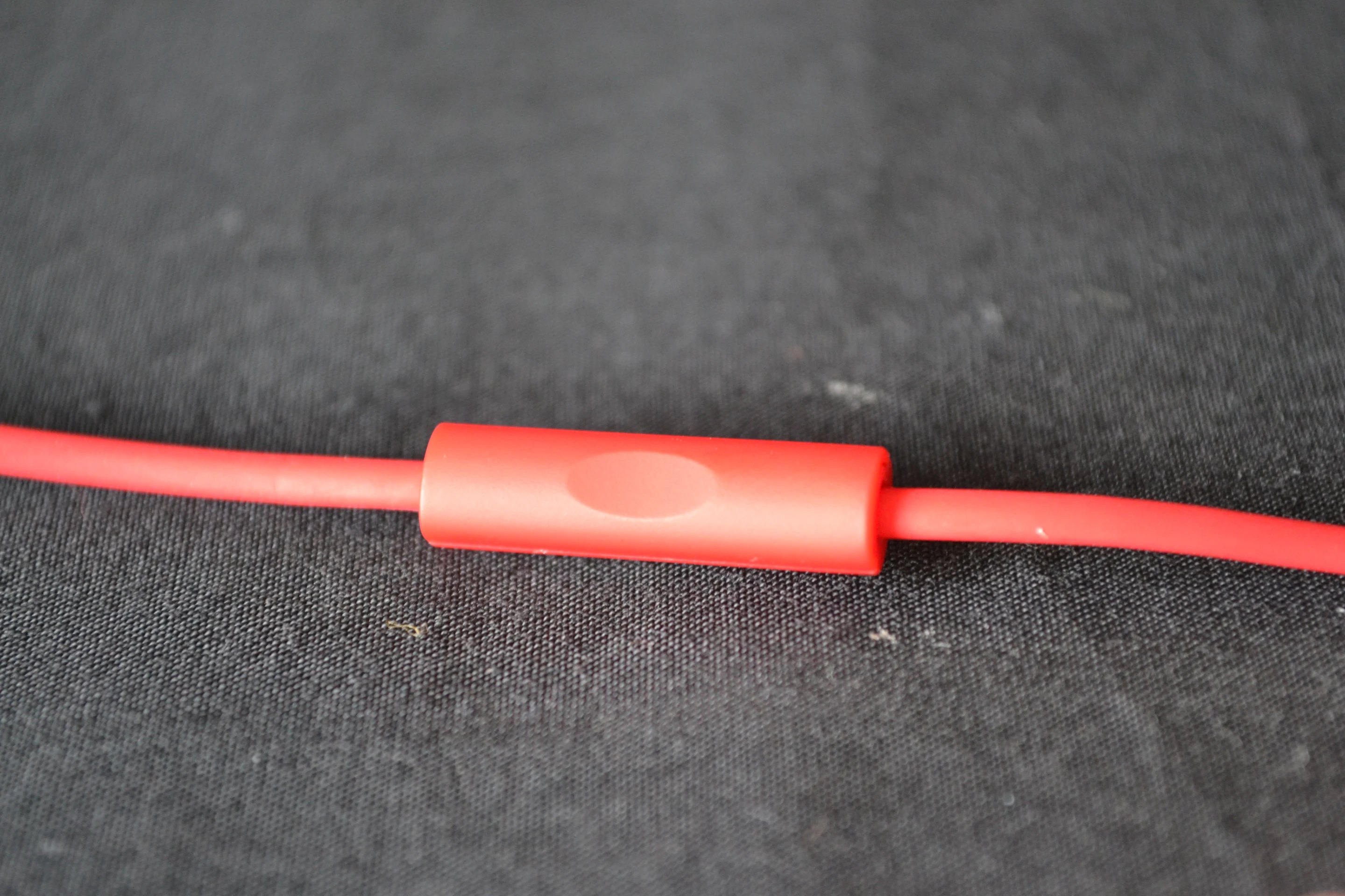 The front of the playback control positioned midway between the Y junction and the right earpiece