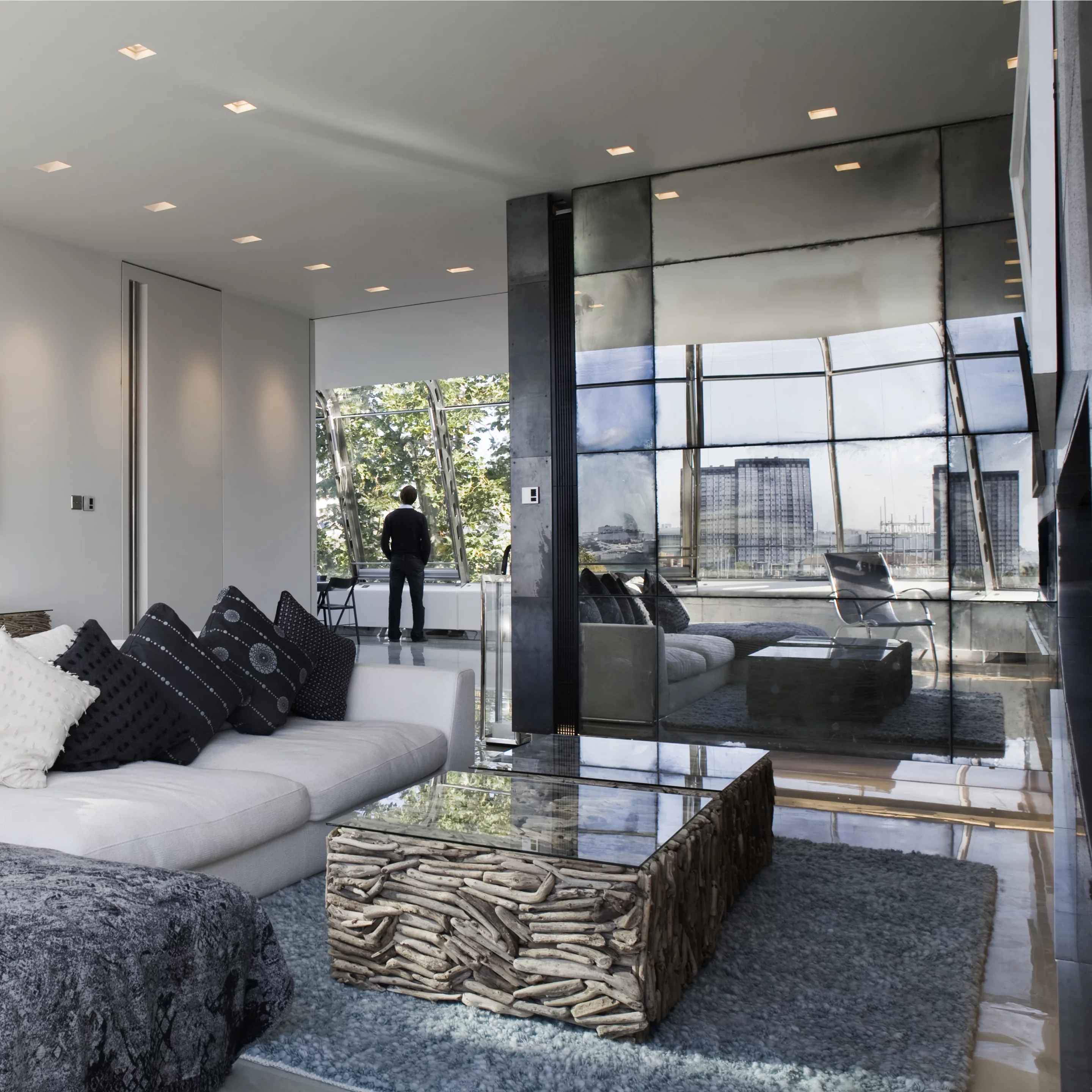 The shape of the home essentially serves to add a Mansard roof to the existing buildings