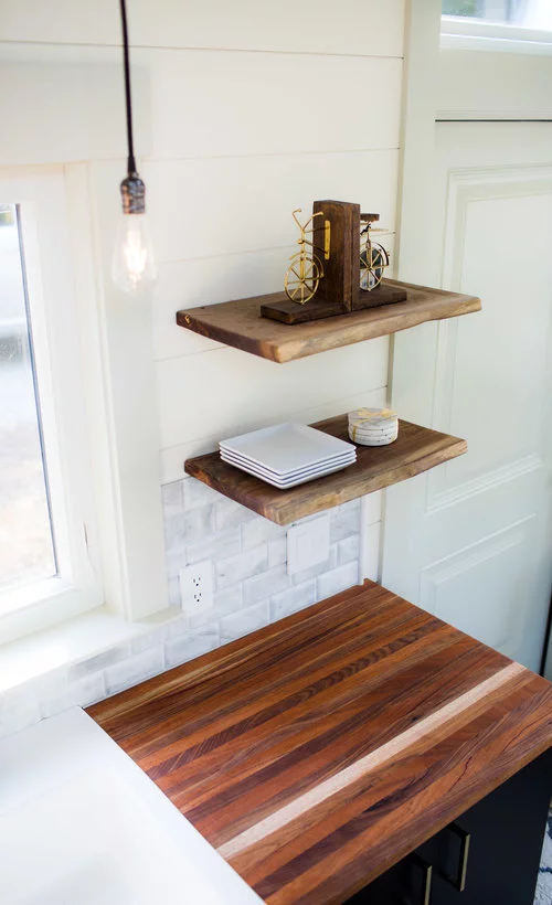 Floating walnut shelves inside the Legacy tiny house