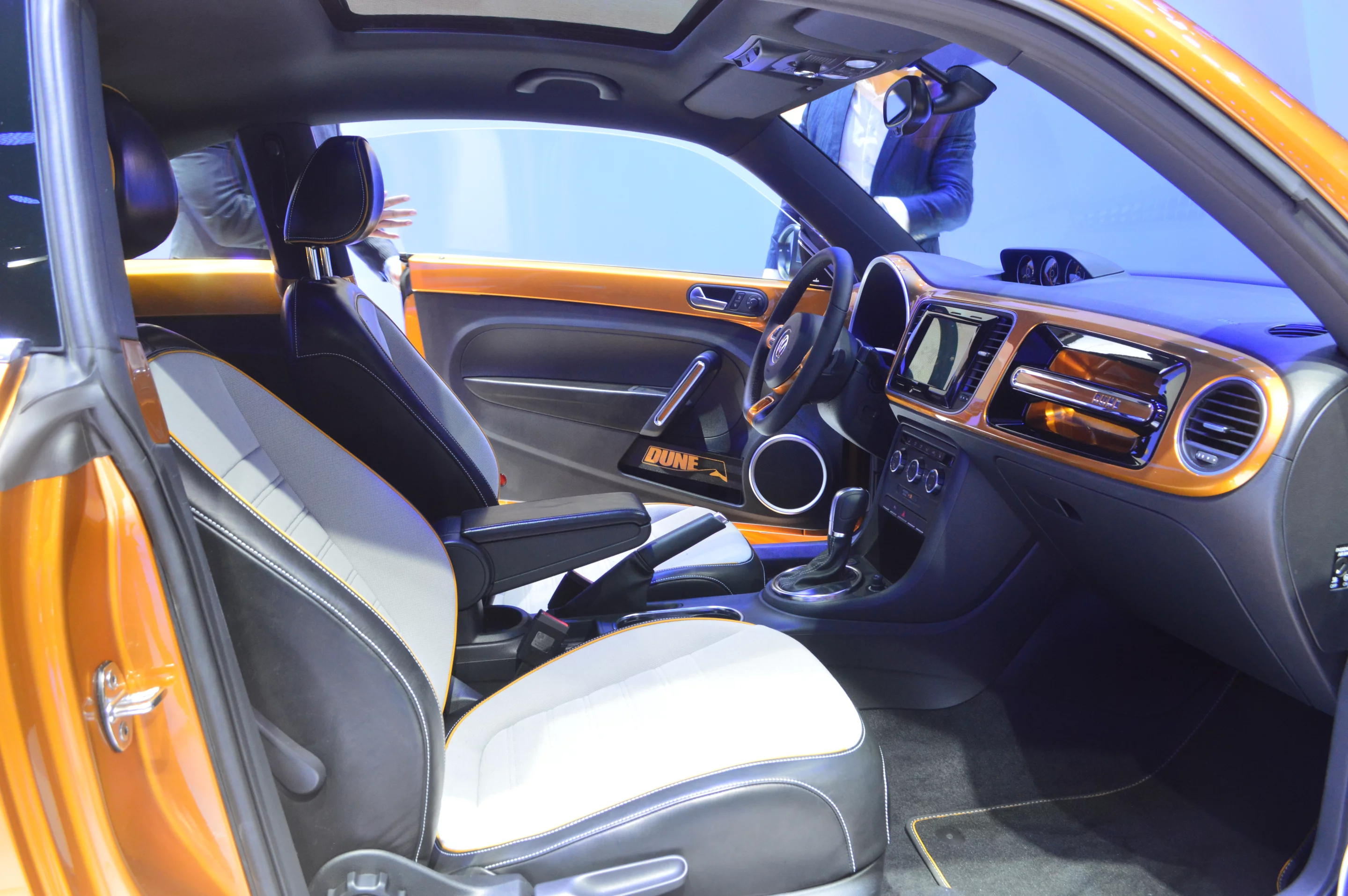 The interior features black leather and Gobi sport fabric upholstery, aluminum dash accents, and a high-resolution 7.7-inch AMOLED touchscreen