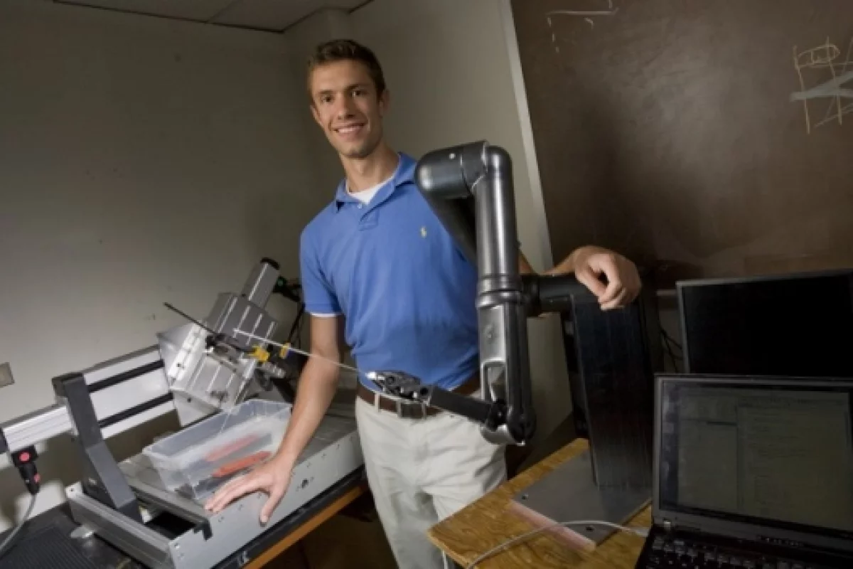 Research team member A. J. Rogers with the shrapnel-finding surgical robot