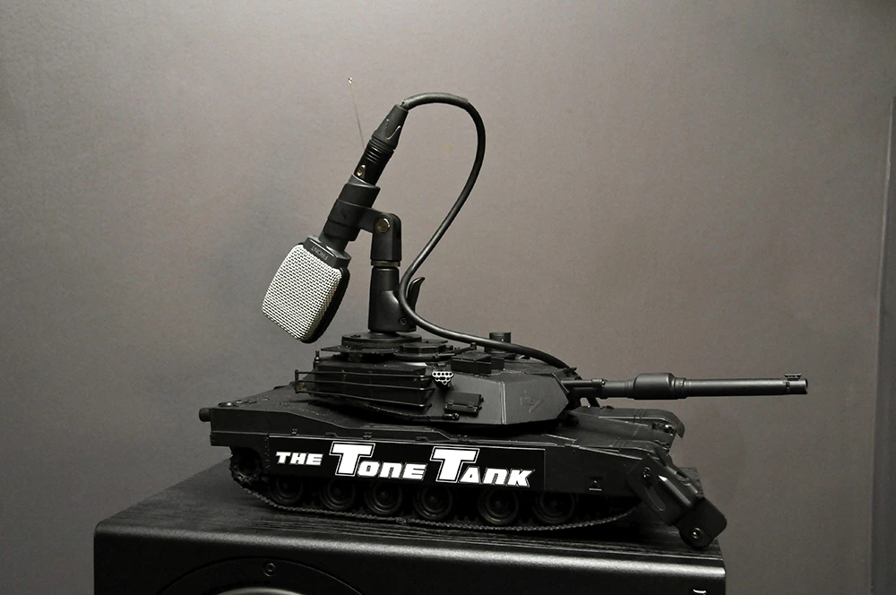 The Tone Tank is an armed, motorized tank sporting a microphone adapter for remote-controlled precision positioning of studio mics