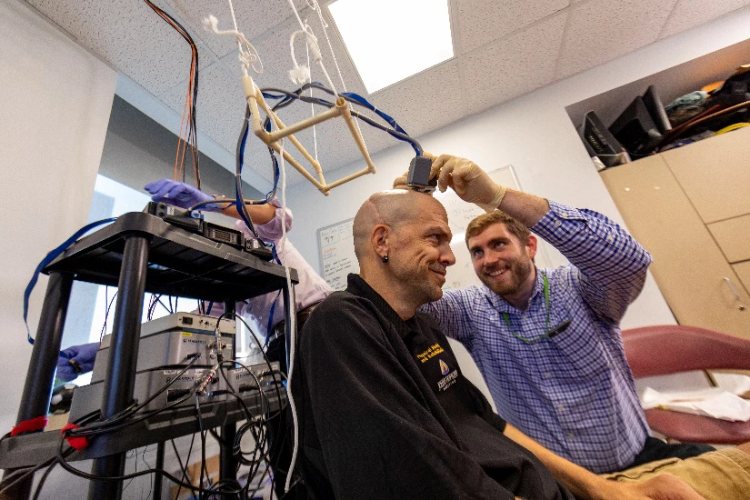 Spinal cord injury patient Buz Chmielewsk with Johns Hopkins University researcher Matt Fifer