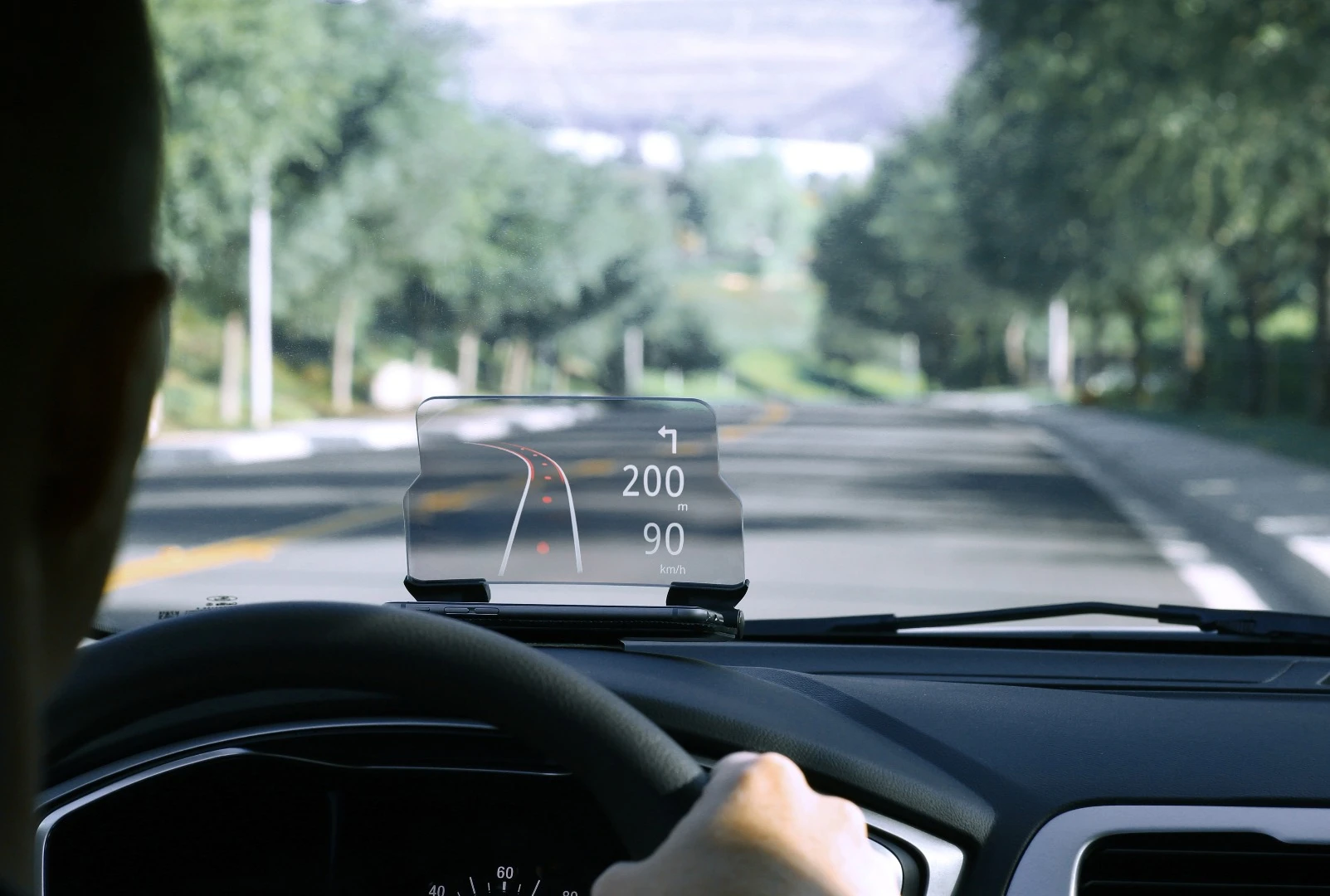 The Hudway Glass is a smartphone cradle that sits on top of your car's dashboard and reflects images from a phone's display onto a curved plastic screen