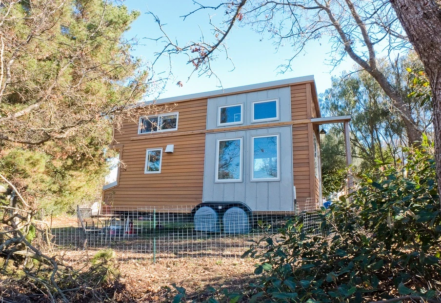 The tiny house has a floor space of 8 x 20 ft (2.4 by 6 m) and features an elevated loft half that size