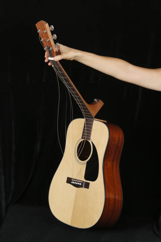 The neck is folded forward, and the strings tucked inside the body