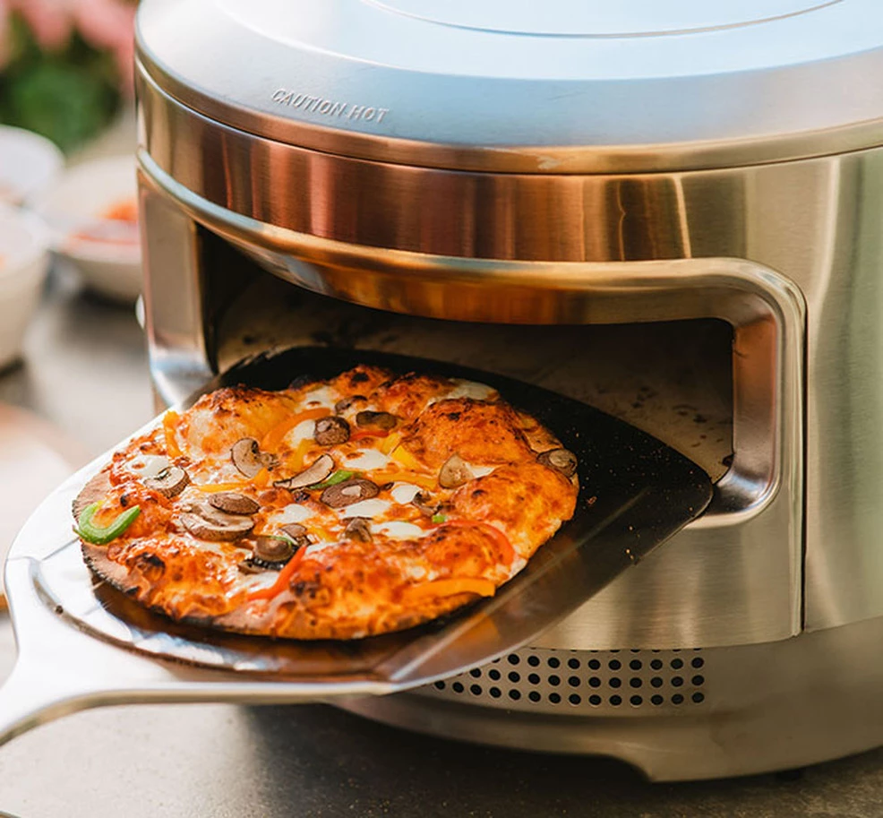 Sliding a pizza out of the new Solo Stove Pi
