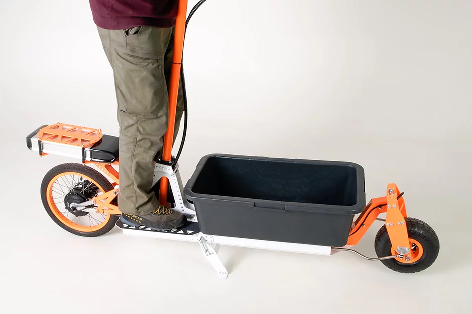 The stand-up electric cargo scooter comes with a 70 x 40 x 22-cm plastic bucket out front