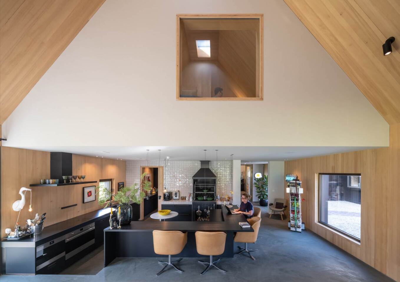 The first barn-house boasts an extra-large modern kitchen, dining area and elevated work cove
