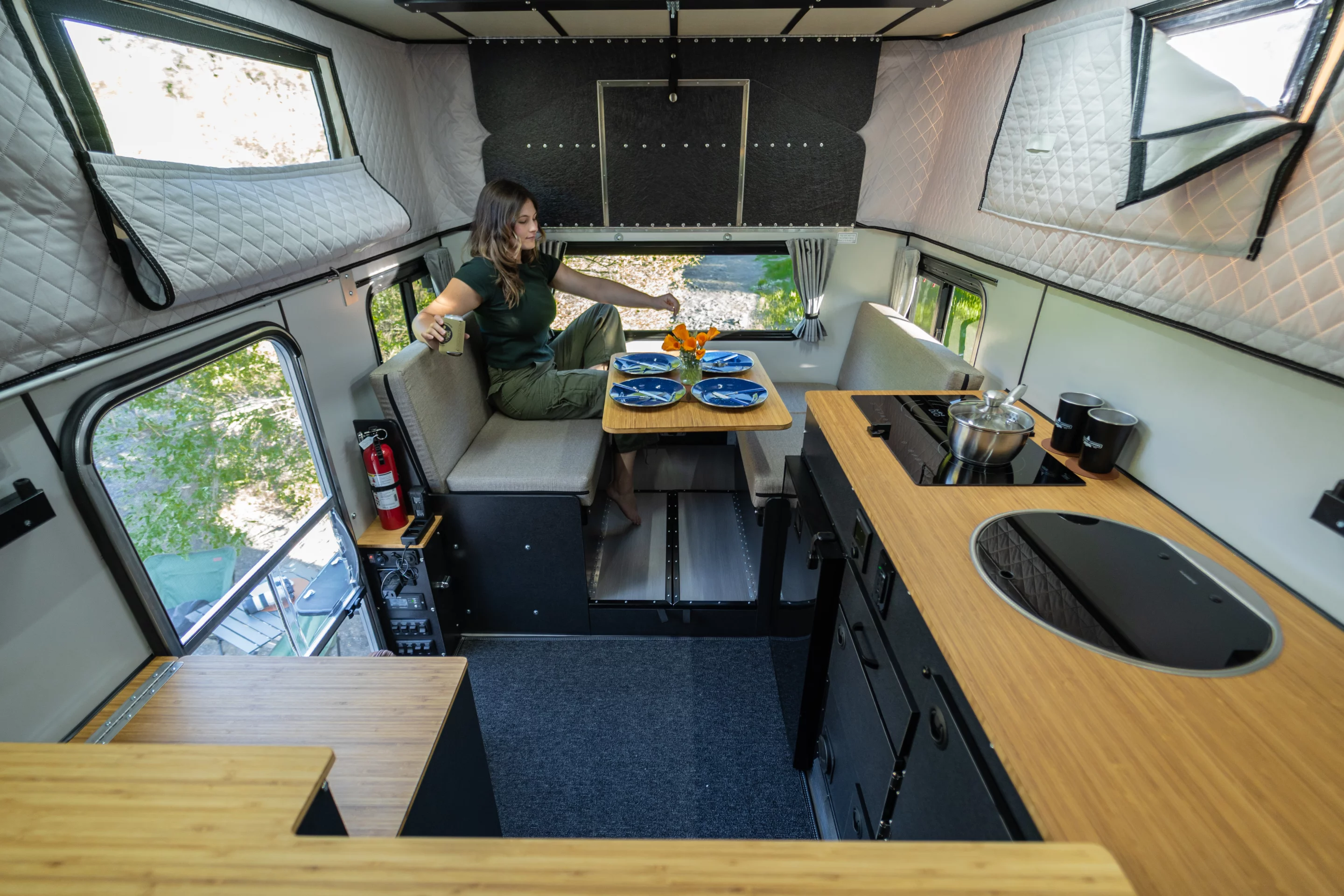 Four Wheel makes efficient use of the compact interior with a four-seat dinette/bed/optional shower area, a full side kitchen and an over-cab queen bed that can be upgraded into a slide-out king