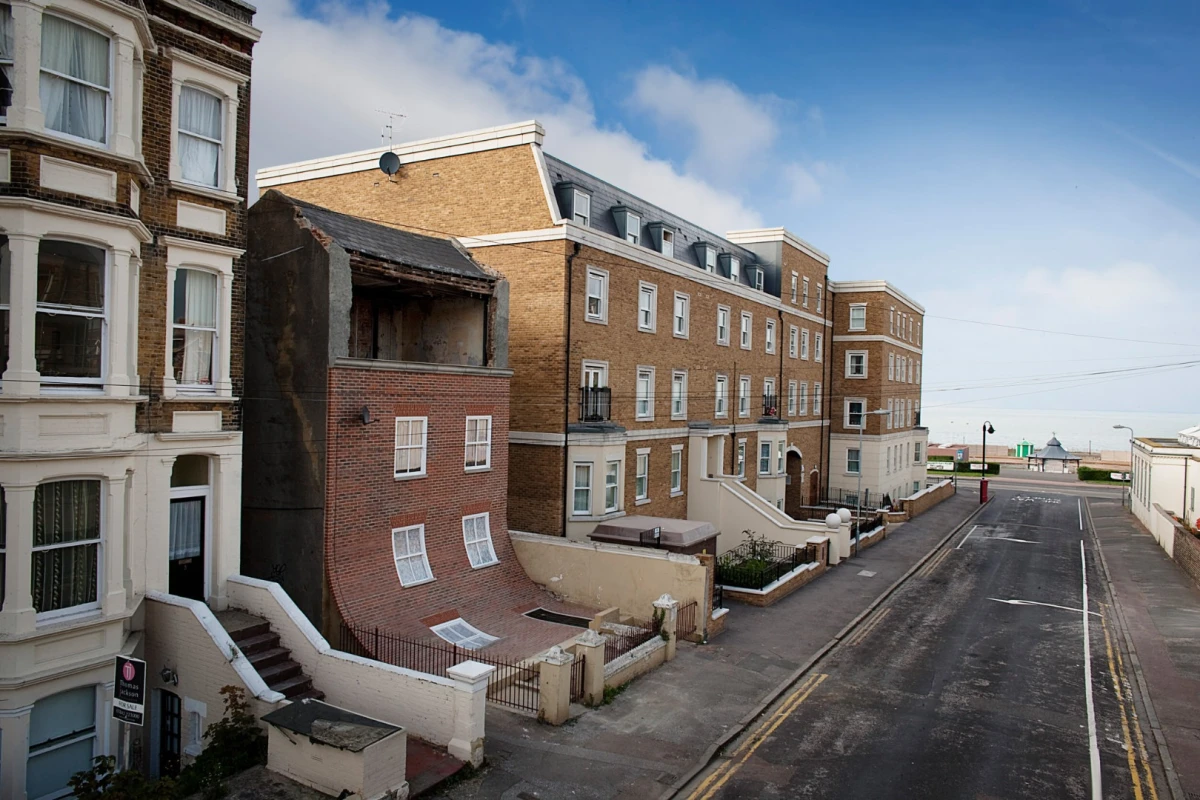 From the knees of my nose to the belly of my toes gave the impression a facade was slipping off the building, revealing a top floor usually hidden behind brickwork