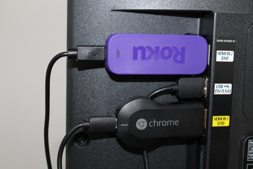 Both the Chromecast and Roku devices connect to an HDMI port in a TV and are powered by a neighboring USB port