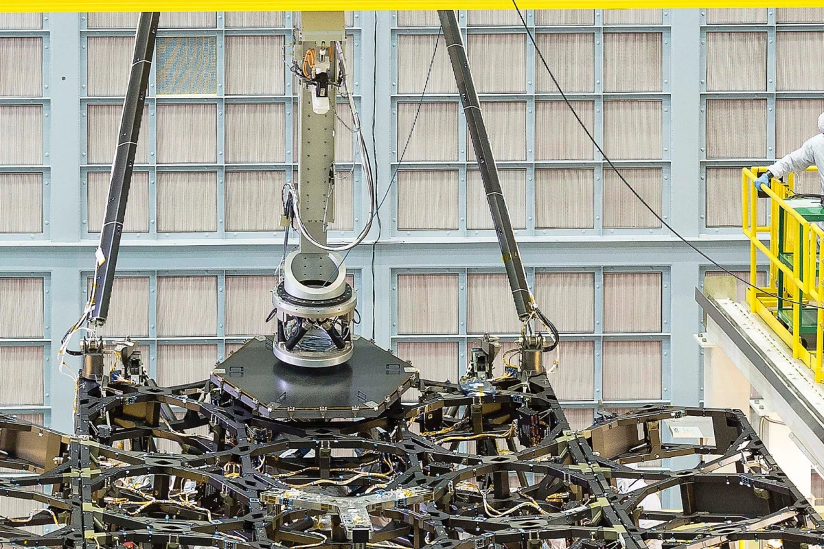 The Goddard team used a robotic arm to carefully lower the hexagonal mirror into place
