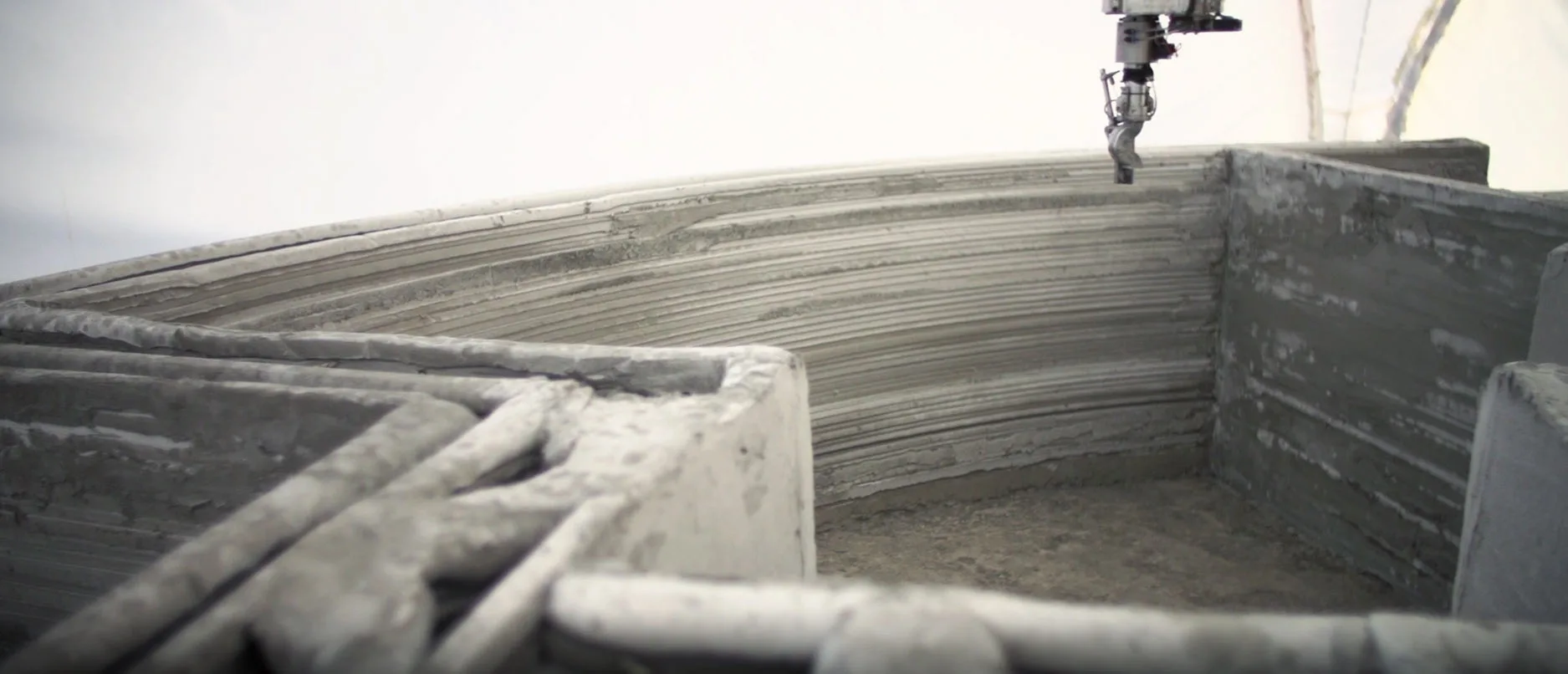 The printing process itself is similar to the other 3D-printed architecture we've reported on and involves extruding cement in layers