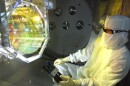 A scientist inspecting one of LIGO's mirrors, which has now been measurably affected by quantum fluctuations